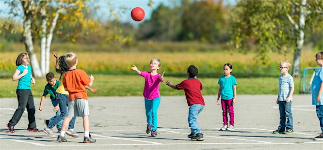 children playing with a ball outside on a sunny day back to school after covid-19