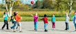 children playing with a ball outside on a sunny day back to school after covid-19