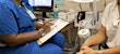 Nurse taking vital signs with patient at medhelp