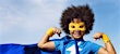 boy wearing superhero costume with cape and mask