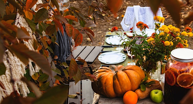 table set for thanksgiving outside for a safe thanksgiving dinner in covid