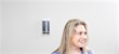 female patient wearing a blue shirt sitting a safe exam room at medhelp urgent care