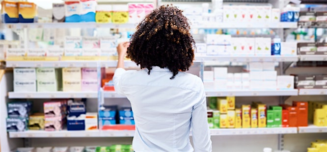 Woman looking at medicine and antibiotics