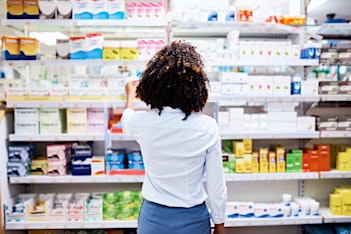 Woman looking at medicine and antibiotics