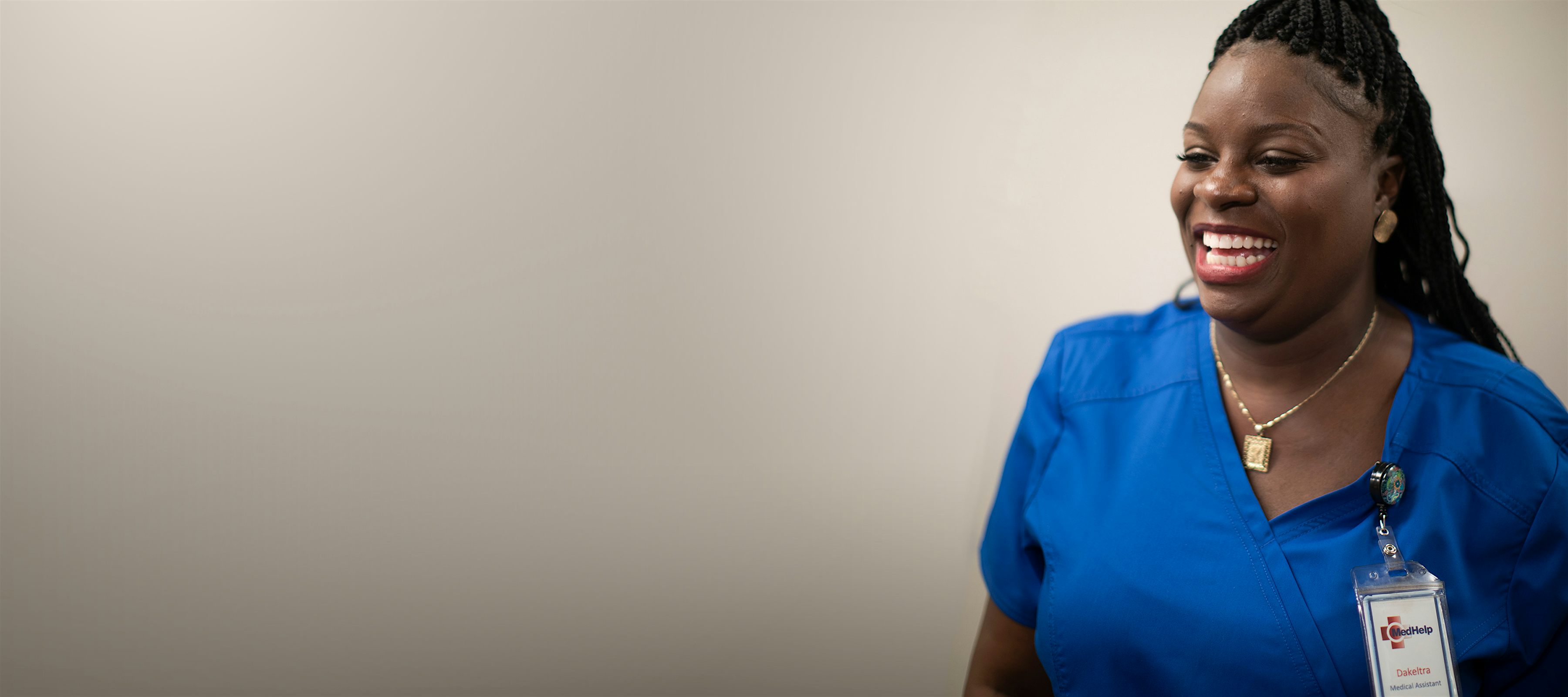 smiling nurse in blue scrubs at medhelp birmingham urgent care clinic