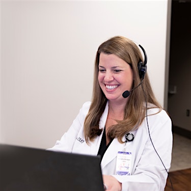 nurse practitioner wearing headset providing online telehealth virtual doctor visit